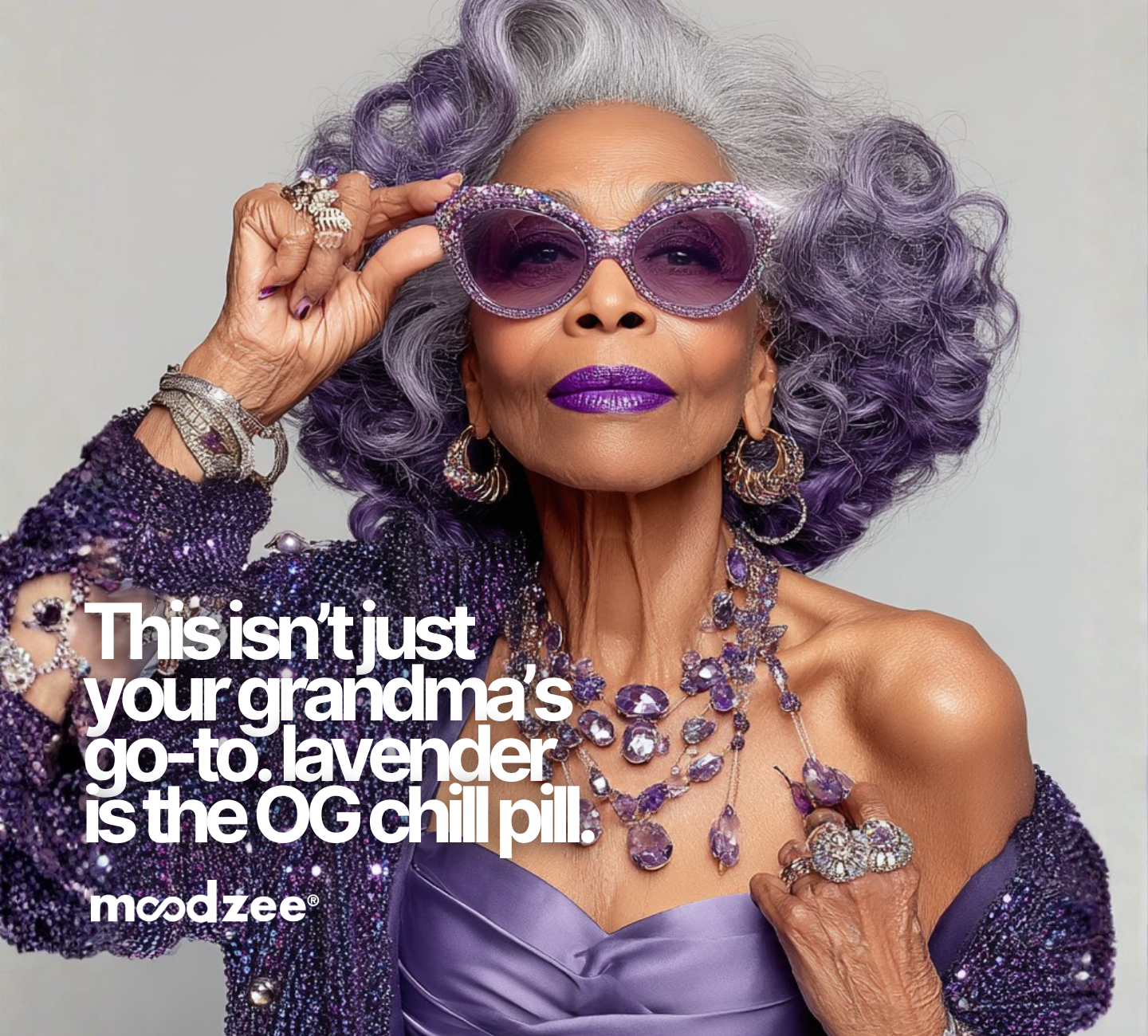 Glamorous silver-haired Black woman in purple sunglasses, bold purple lipstick, and amethyst necklaces with text "This isn't just your grandma's go-to. Lavender is the OG chill pill." Moodzee logo