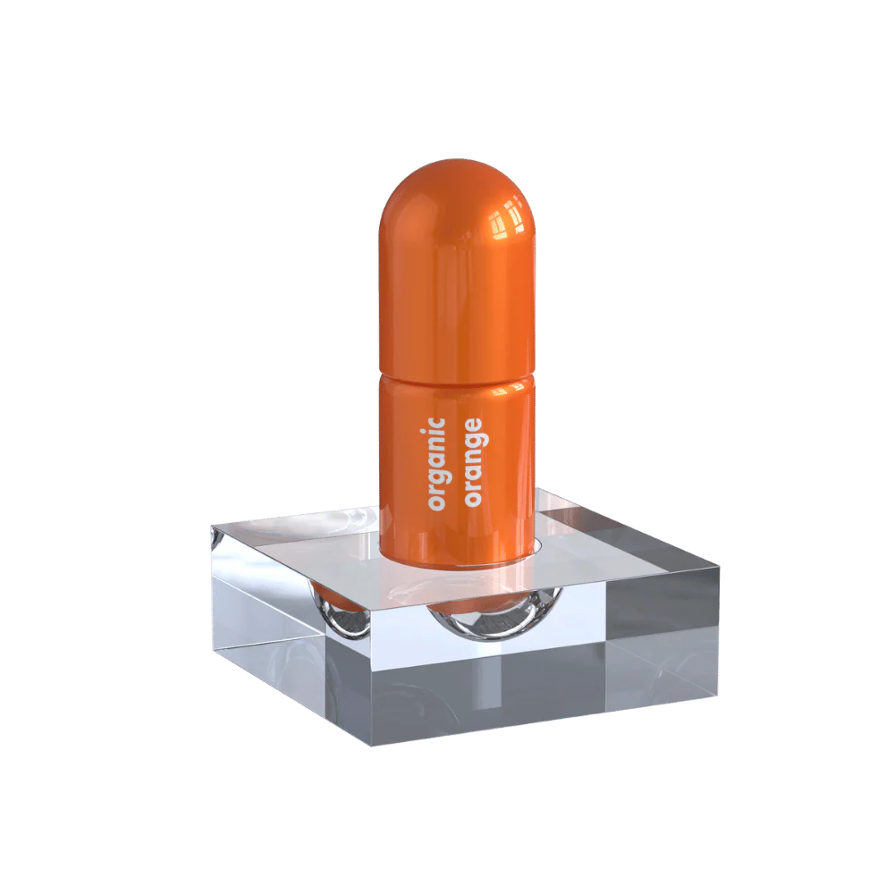 Orange Moodzee roller ball being applied to pulse point